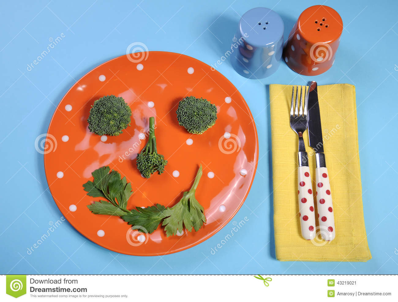 Plate With Salt And Pepper Shakers And Colorful Cutlery On A Pale