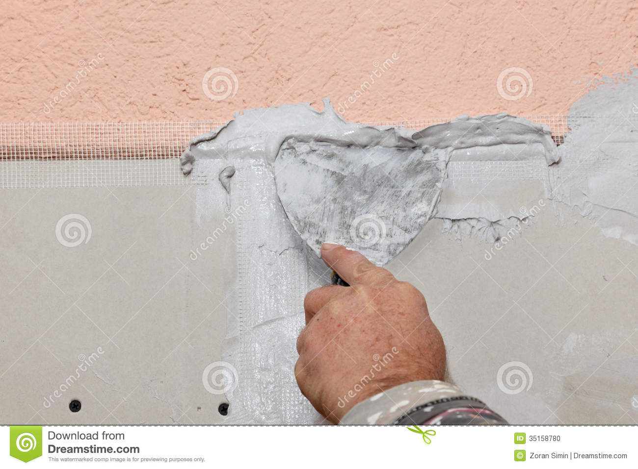 Worker Spreading Plaster With Trowel To Gypsum Board And Fiber Mesh 