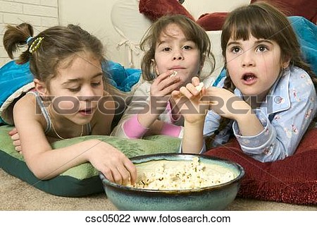 Stock Photo   Young Girls Eating Popcorn At A Sleepover  Fotosearch