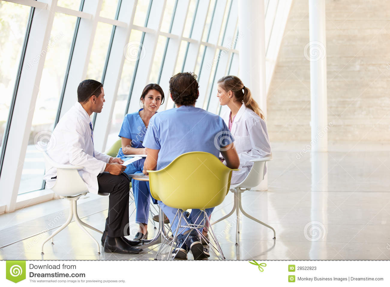 Medical Team Meeting Around Table In Hospital Stock Photos   Image