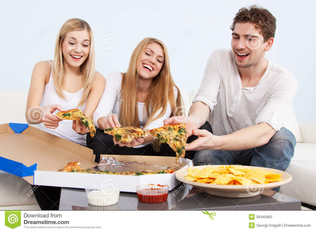 Group Of Young People Eating Pizza At Home Stock Photos   Image