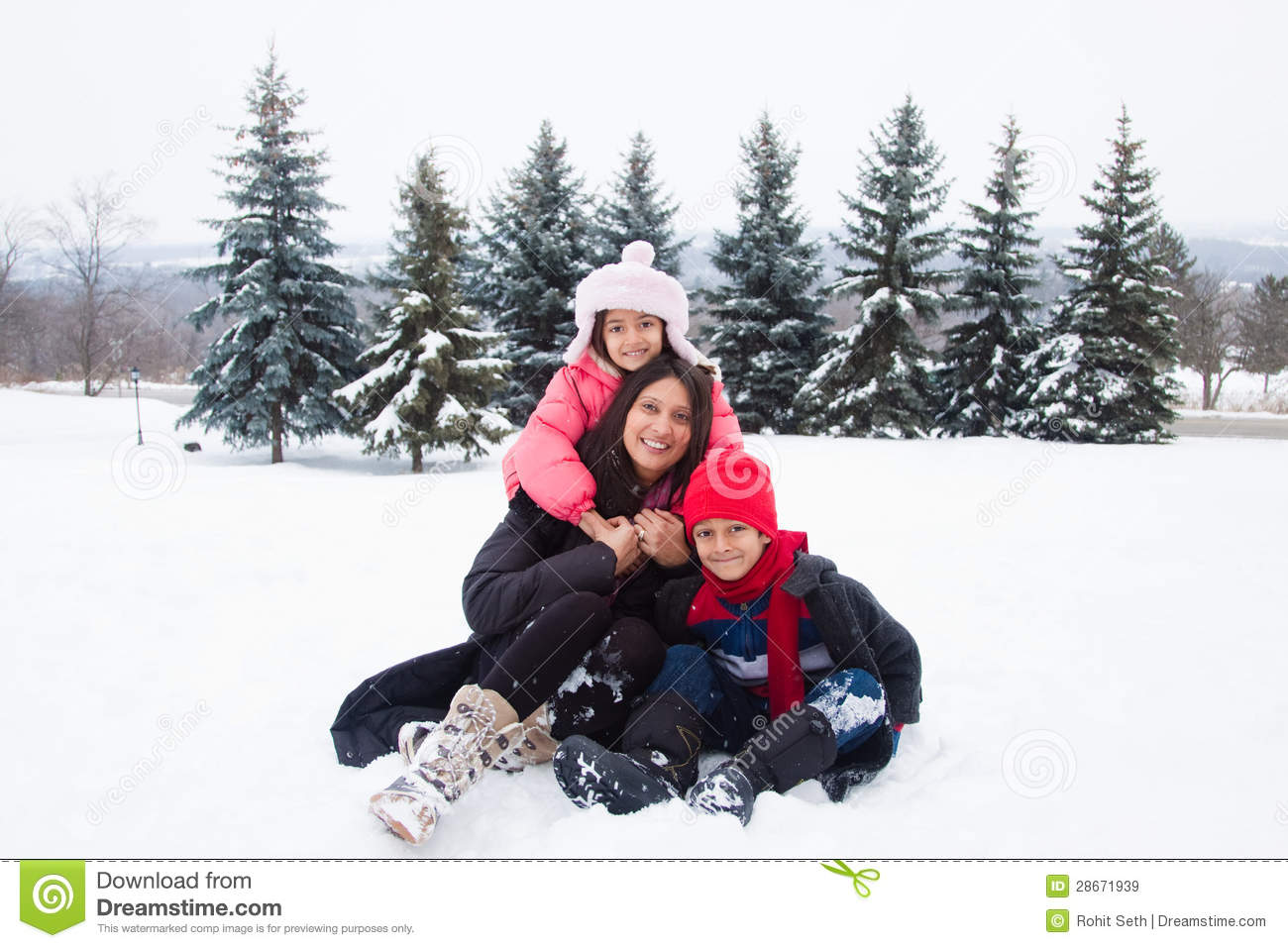 East Indian Family Playing In The Snow Royalty Free Stock Images