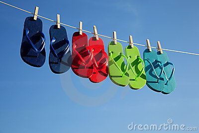 Blue Green Red Turquoise Flipflops Hanging On A Clothes Line With
