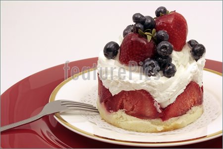 Strawberry And Blueberry Cheesecake Decorated With Chantilly Cream And