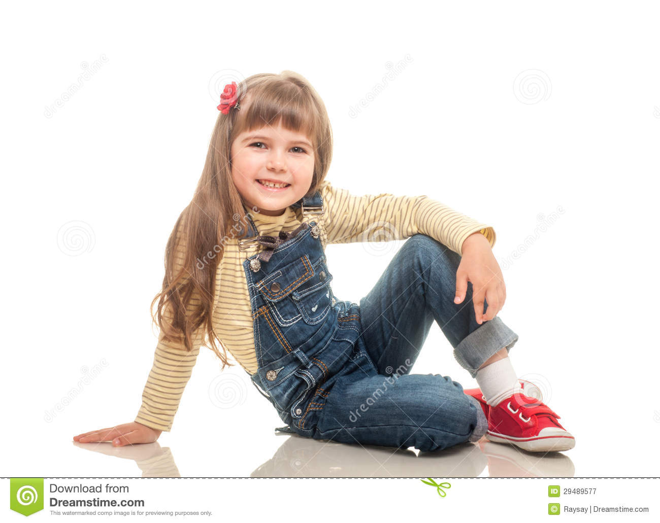 Cute Little Girl Wearing Jeans Overall Sitting On The Floor And