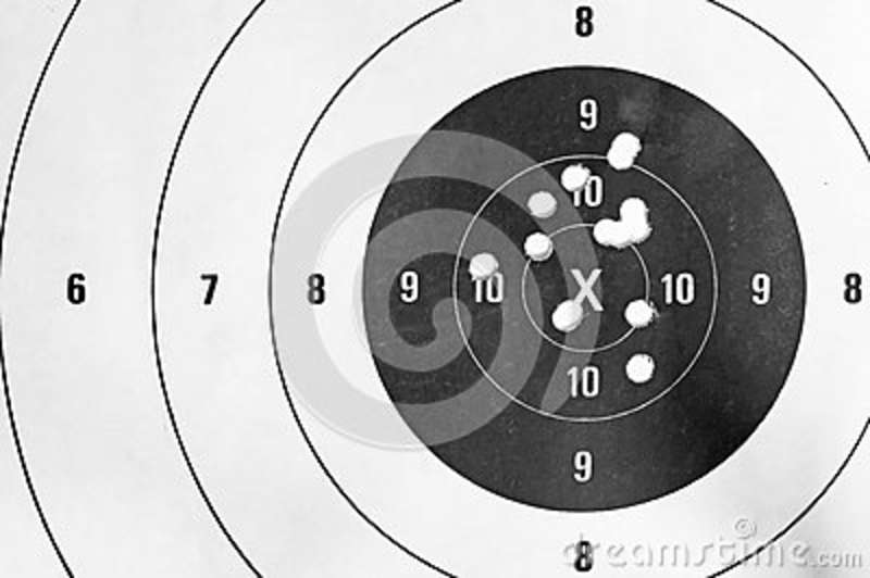     White Close Up Of A Shooting Target And Bullseye With Bullet Holes