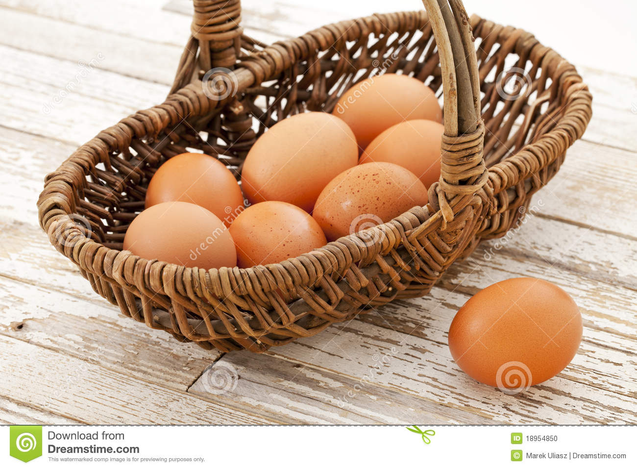 Basket Of Brown Chicken Eggs Against Grunge Wooden Table With White