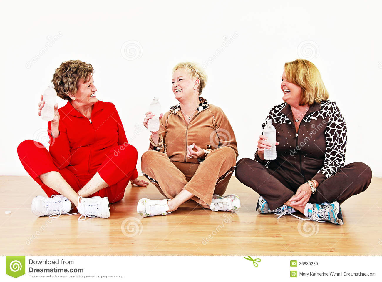 Senior Women With Water Socializing In A Row In An Exercise Class