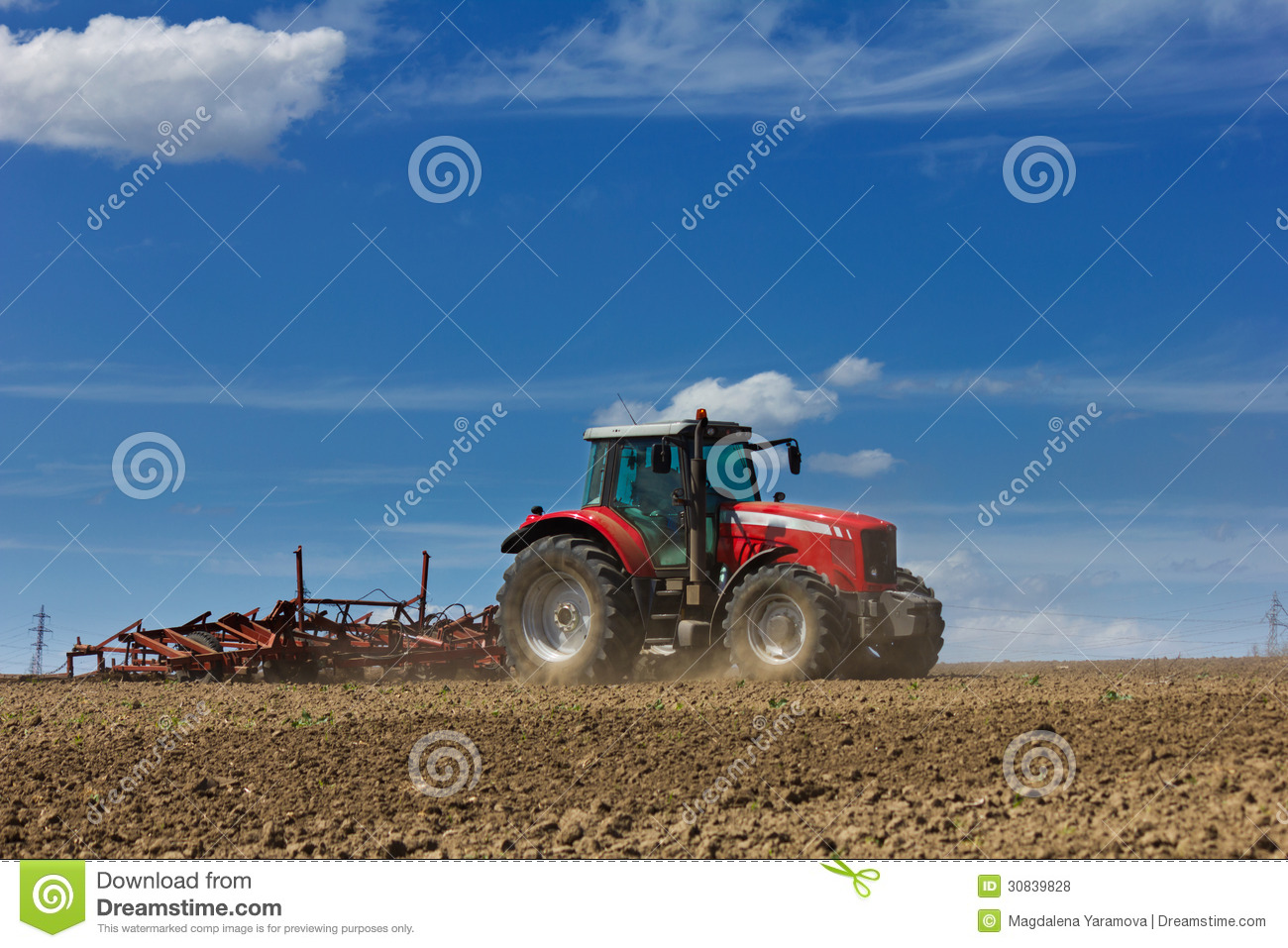 Plowing The Field  Cultivating Tractor In The Field  Red Farm Tractor