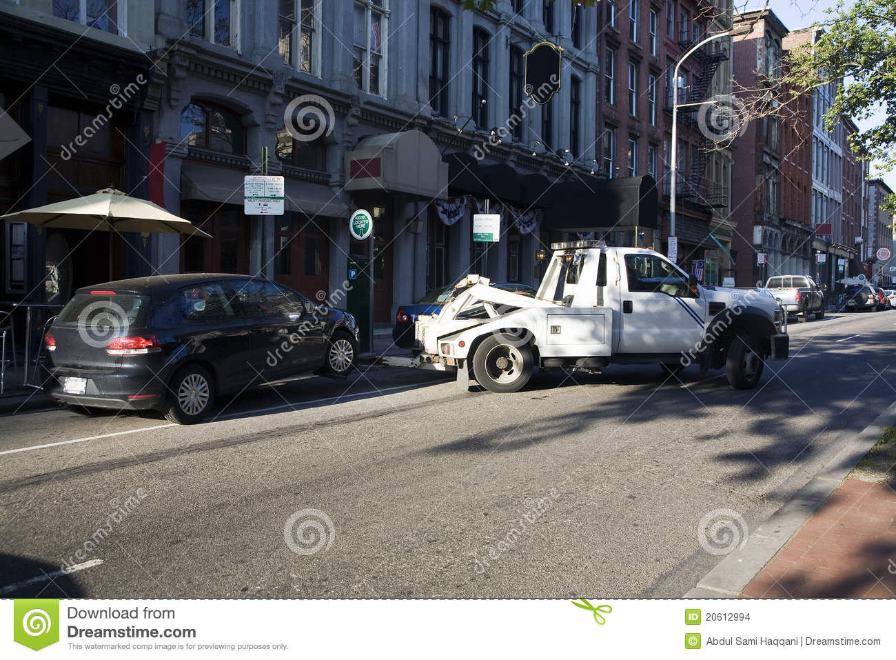 Car Being Towed Away By Truck Due To Illegal Parking