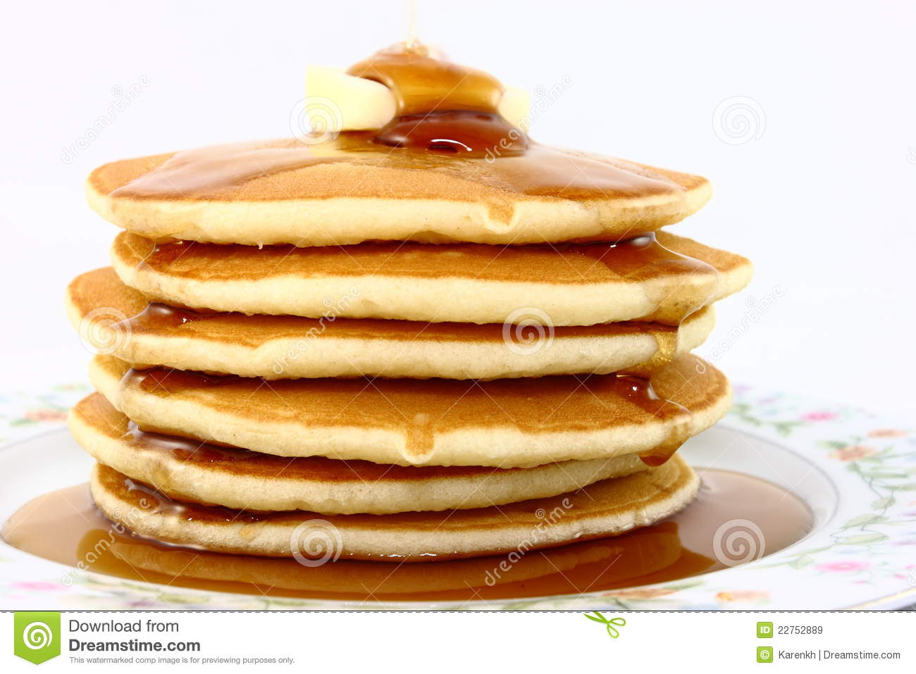 Tall Stack Of Warm Pancakes On A Floral Plate Topped With Butter And