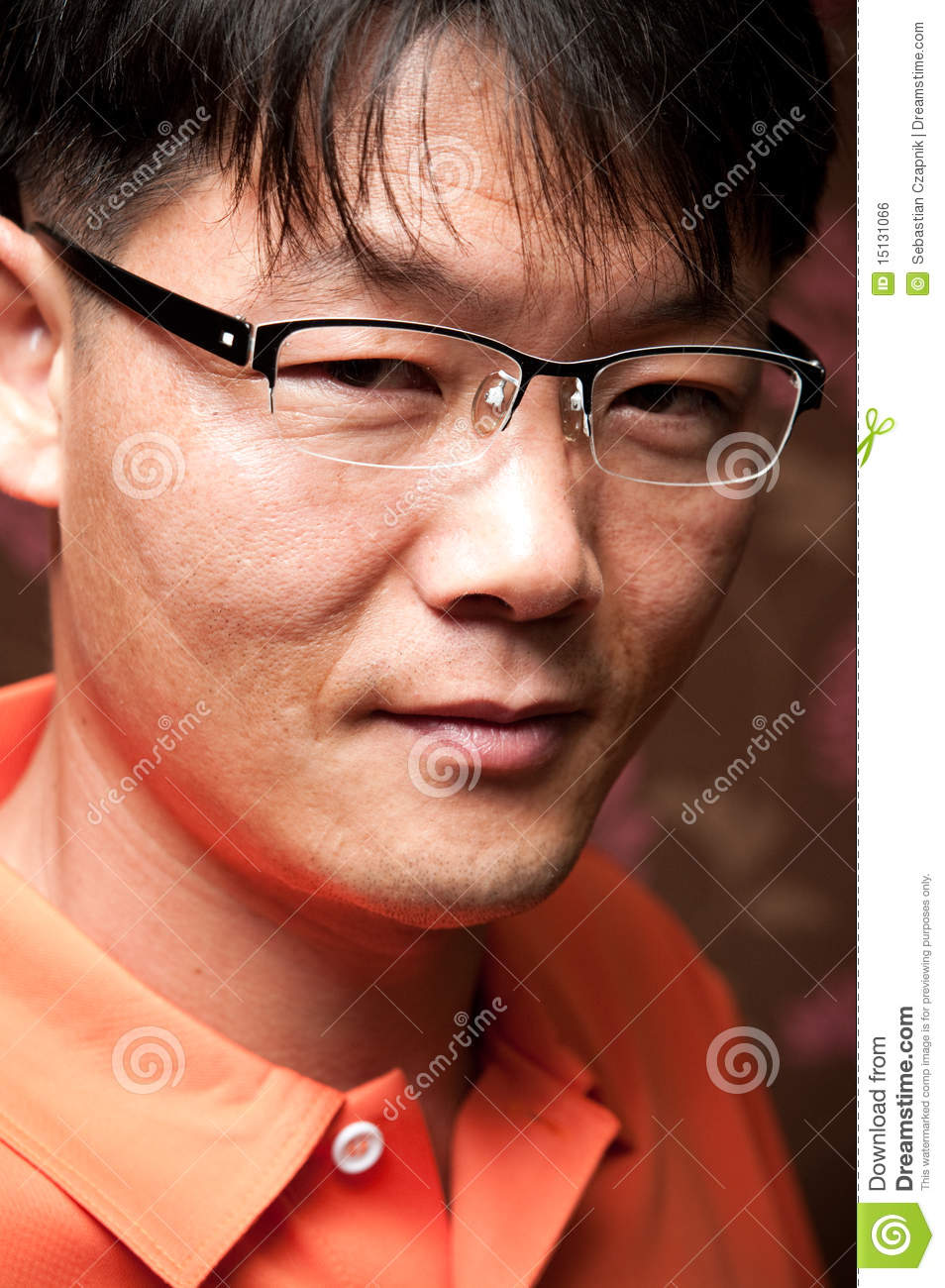 Portrait Of A Handsome Young Asian Man Wearing Glasses