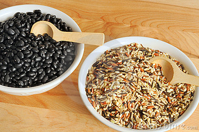 Bowls On A Cutting Board Containing Uncooked Wild Rice And Black Beans