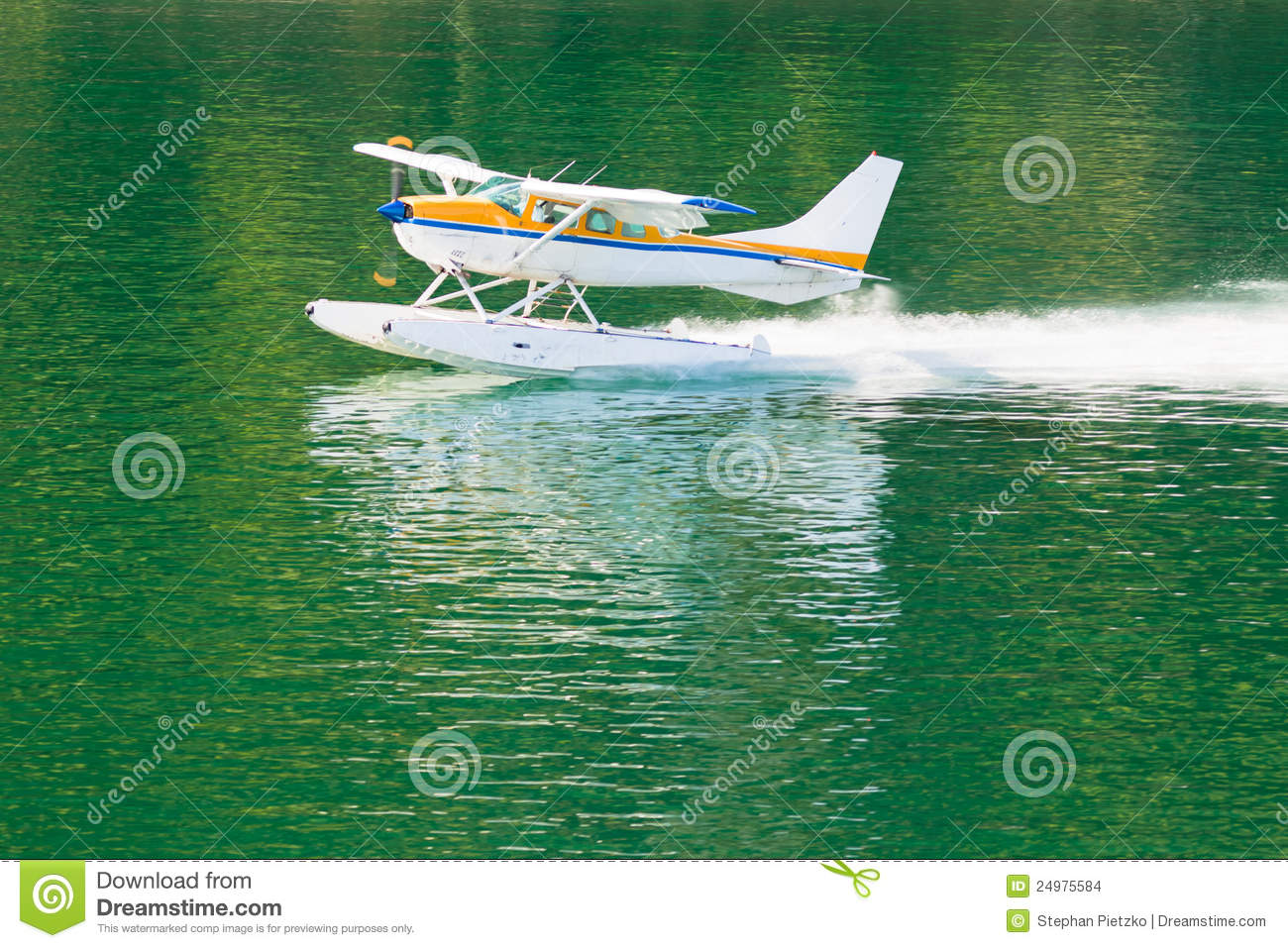 Float Plane Or Hydroplane Takes Off Across Flat Calm Water Of Lake