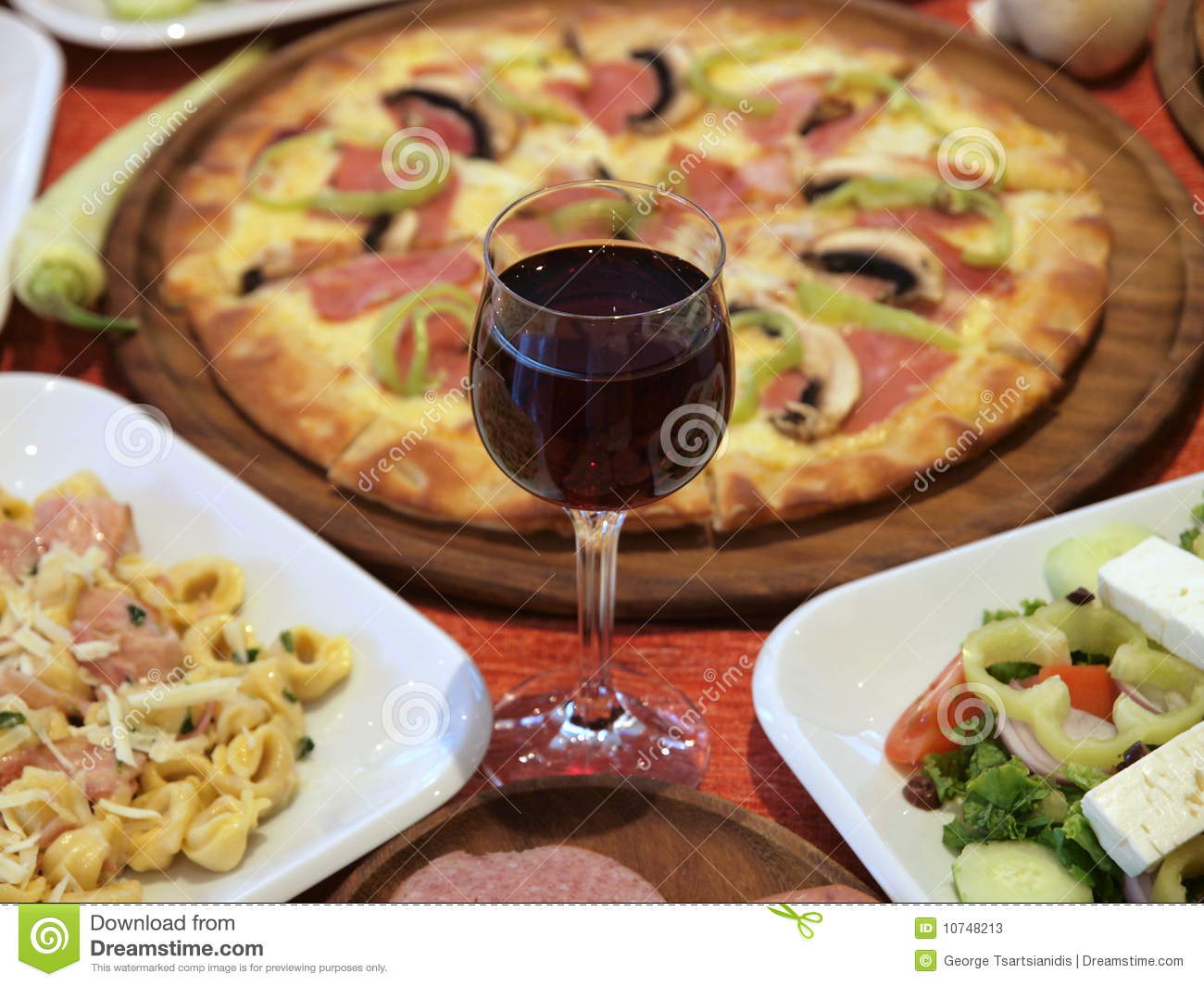 Appetising Italian Feast Of Red Wine Pizza Pasta And Salad 