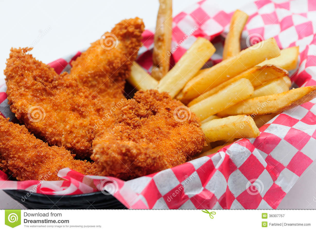 Breaded Chicken Strips With French Fries And Dipping Sauce In A Diner