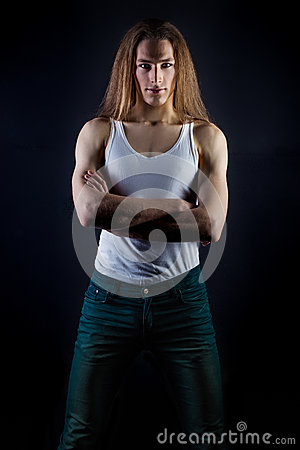 Posing In Studio On Black Background And A White T Shirt And Jeans