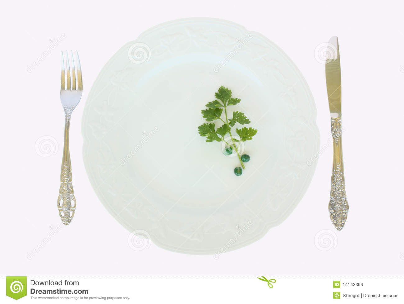 Dinner Plate With Peas And Parsley And Fork And Knife Arrangement