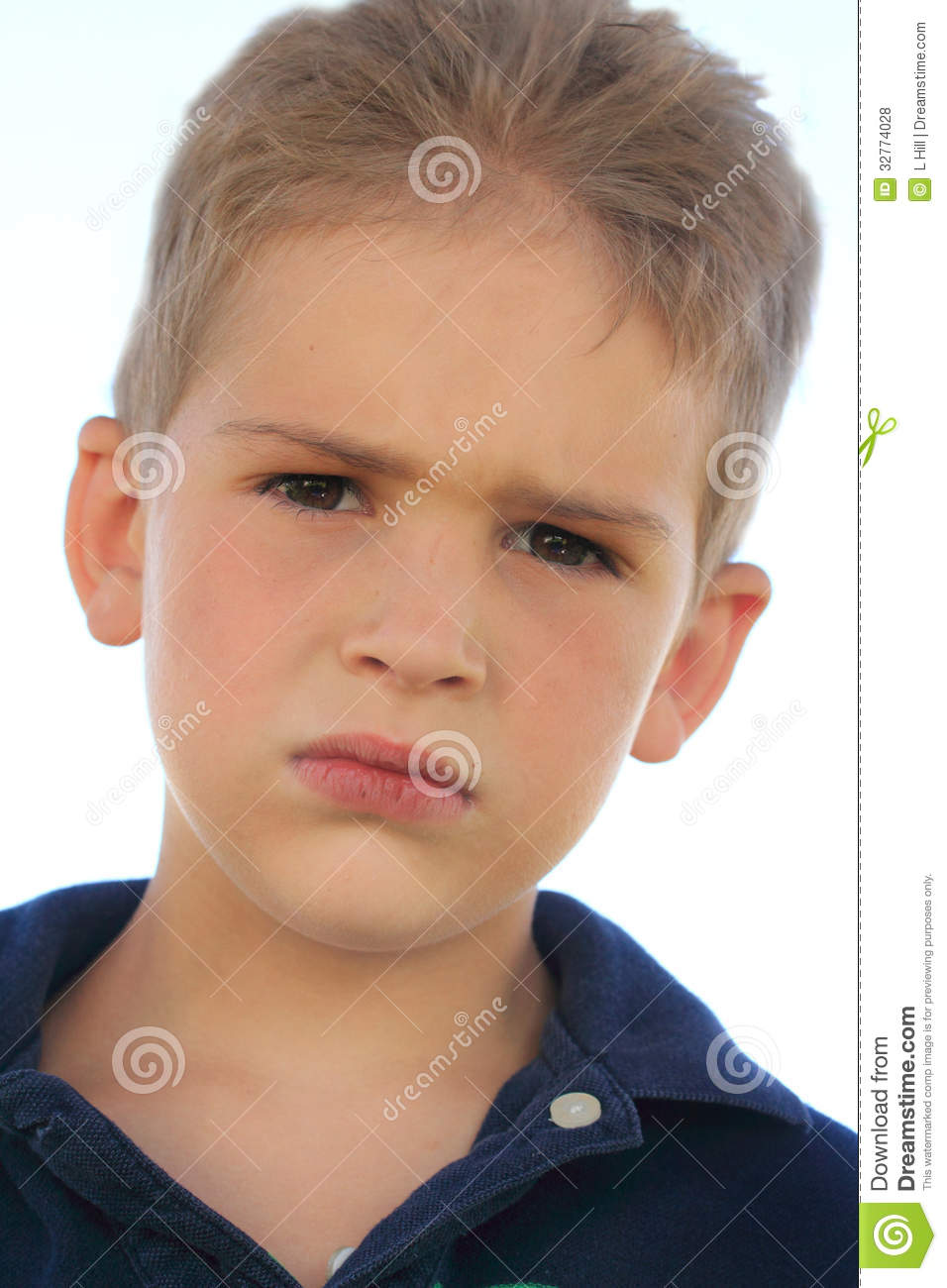 Closeup Of A Cute Little Blond Boy With Grumpy Serious Expression