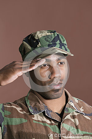 African American Us Marine Corps Soldier Saluting Over Gray Background
