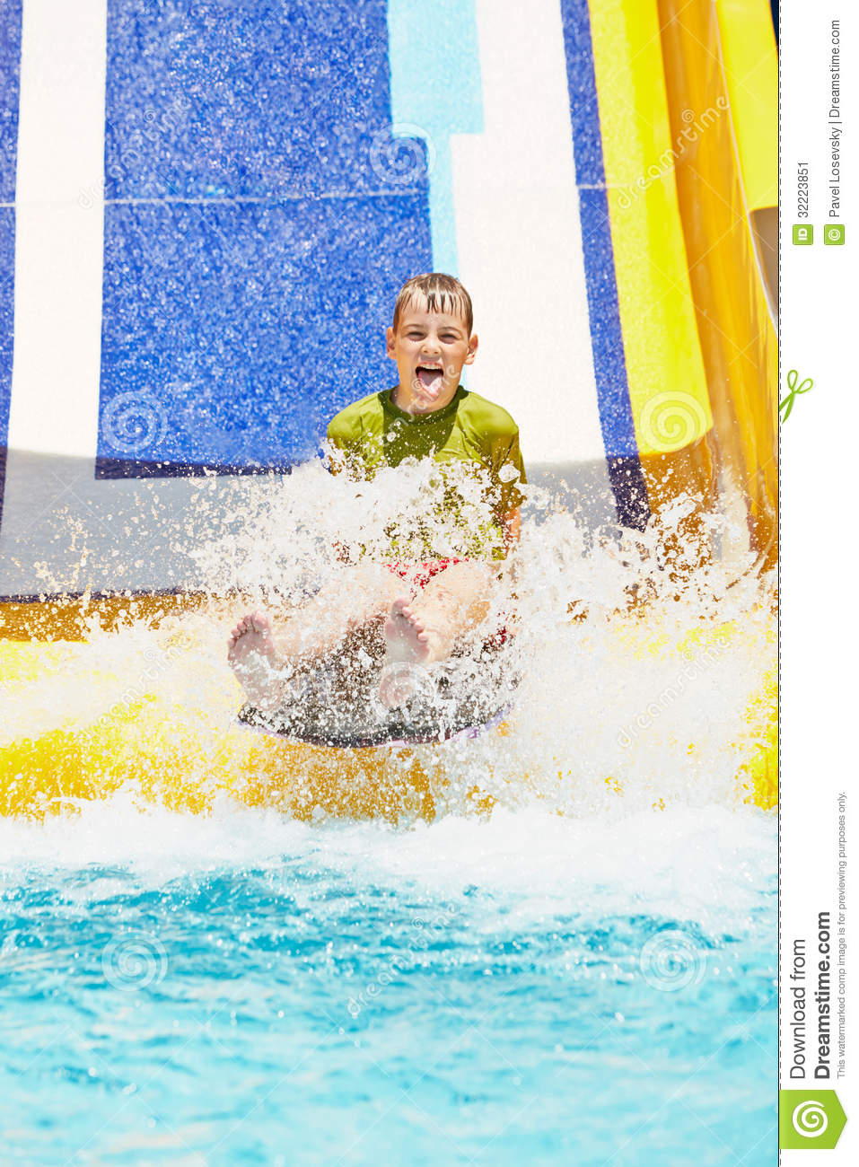 Boy Shouts While Slides Down Water Slide At Summer