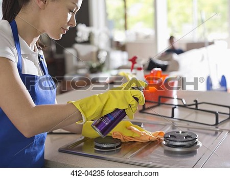 Stock Image Of Maid Cleaning Stove Top 412 04235   Search Stock Photos