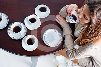 Portrait Of Beautiful Young Woman Drinking Coffee Many Coffee Cups On