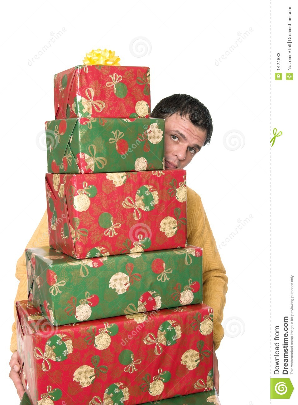 Young Handsome Guy Carrying A Huge Stack Of Christmas Presents