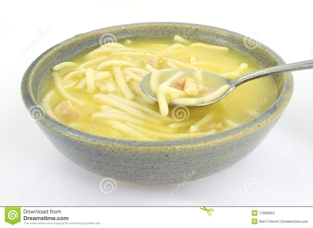 Serving Of Chicken Noodle Soup In An Old Bowl With A Spoon 