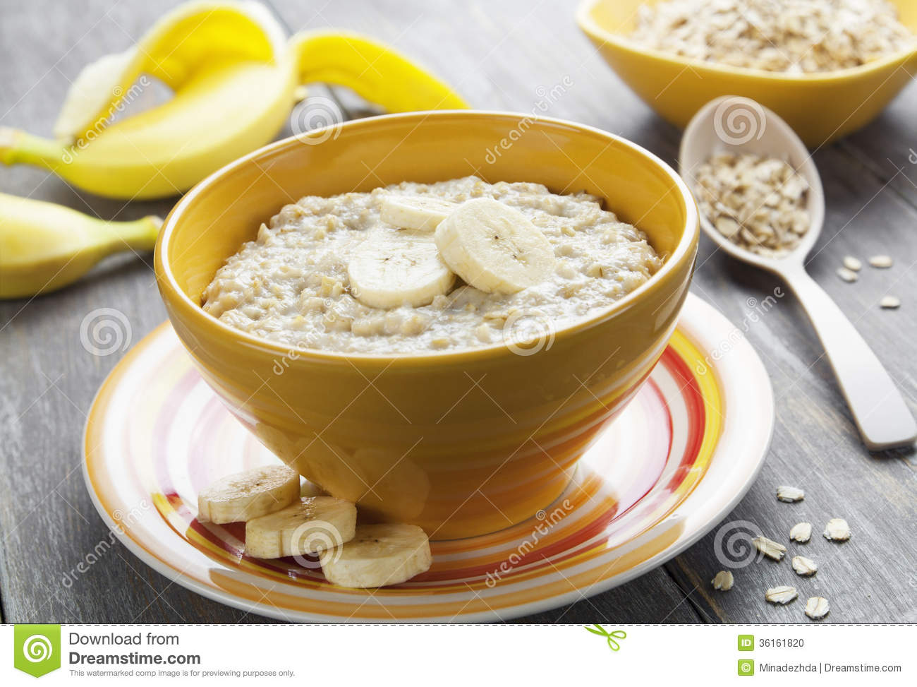 Porridge With Bananas In A Yellow Bowl On The Table