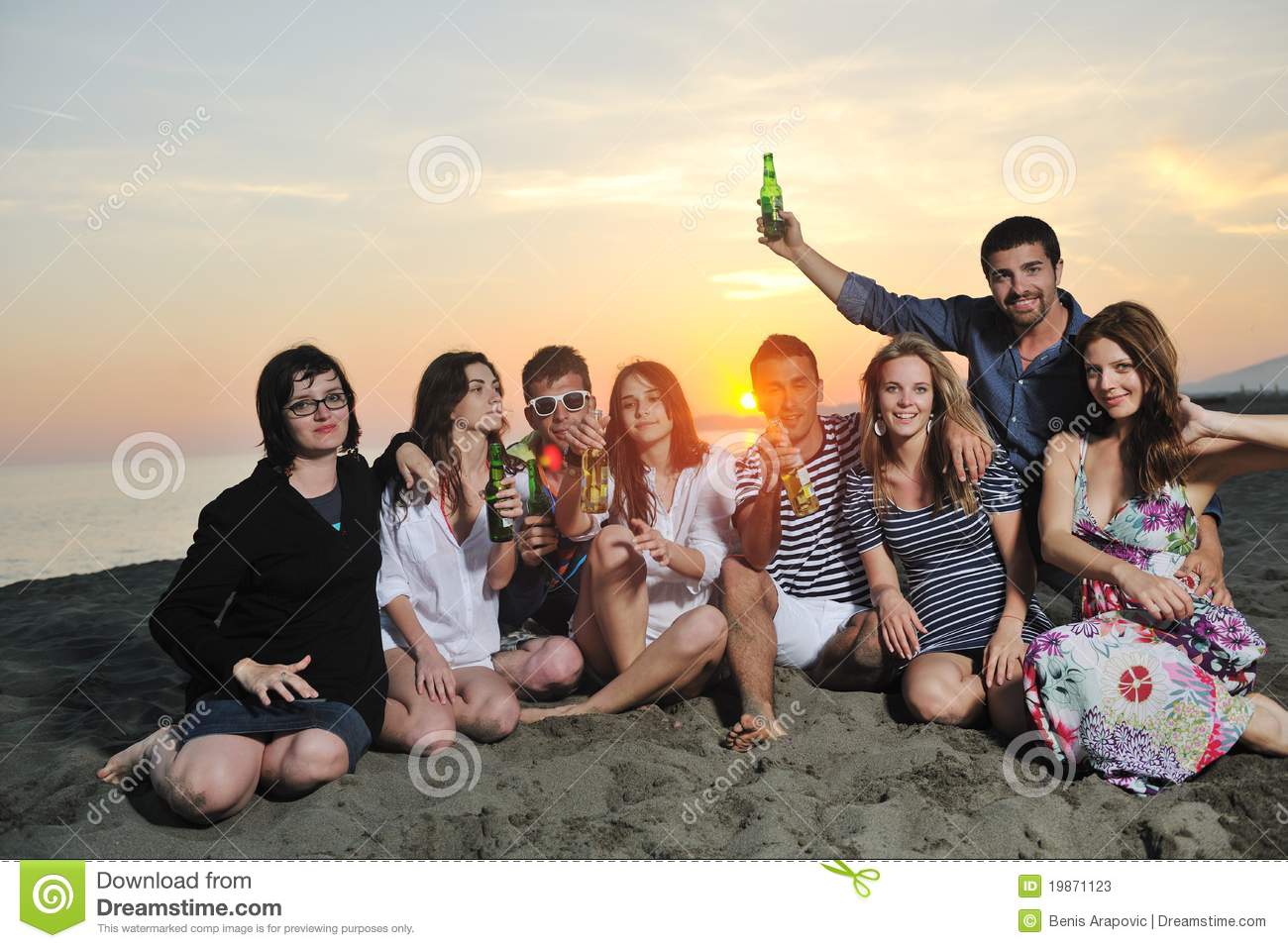 Group Of Young People Enjoy Summer Party At The Beach On Beautiful